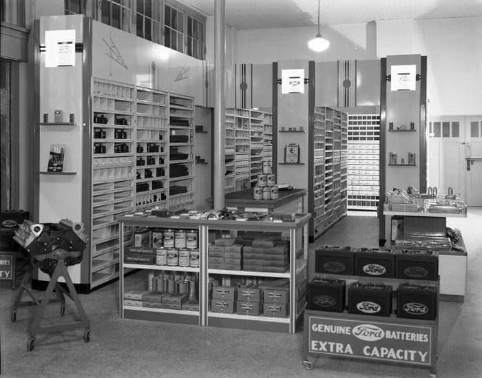 #78 Ford Motor Company products in automotive parts display room, 1950s