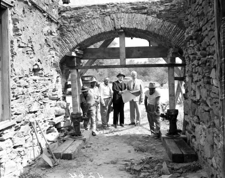 #16 Harvey Smith, Archbishop Lucey, Louis Guido, and workers at Mission Espada restoration, 1955