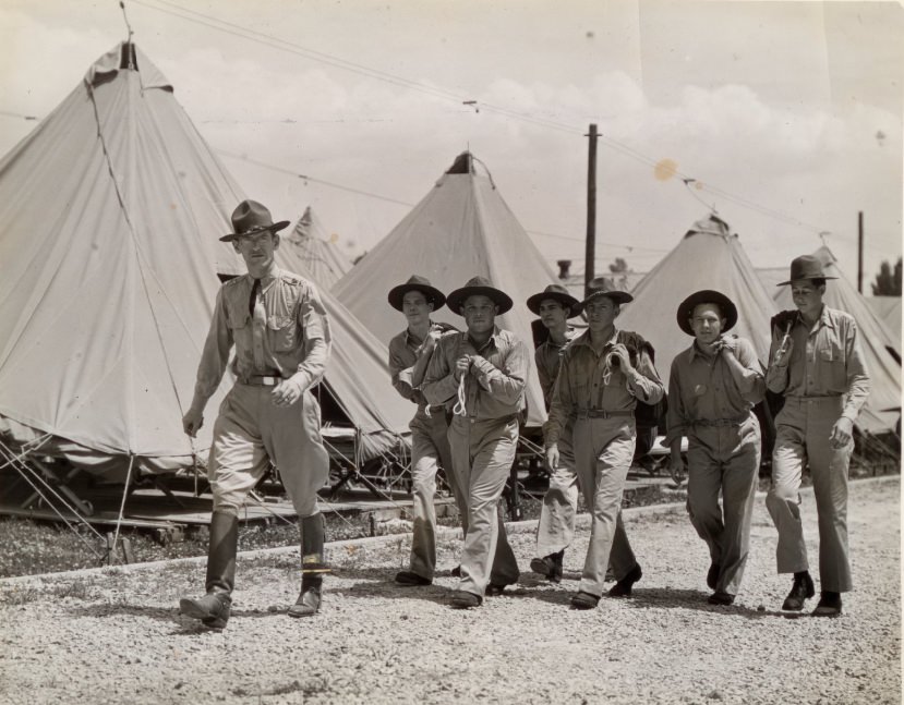 #143 These men had finished their registration and were checking over their newly issued equipment as they rested in the tent assigned them, 1939