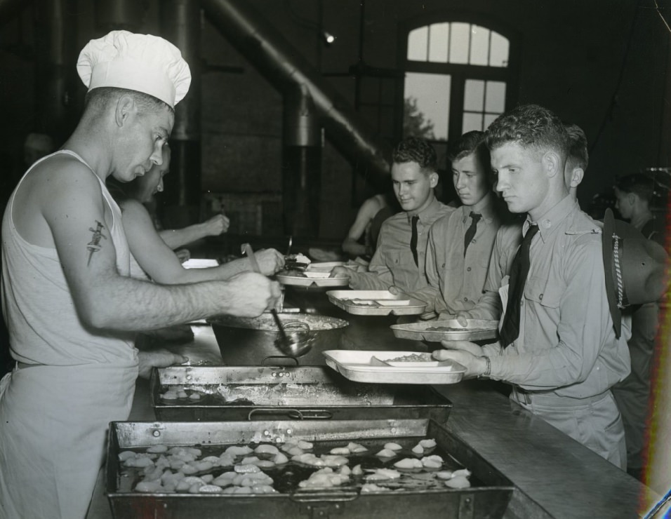 #70 The trainees took time out at noon for a hearty meal of baked beans, tomatoes, salad, bread and apple butter, served cafeteria style and with a minimum loss of time, 1939