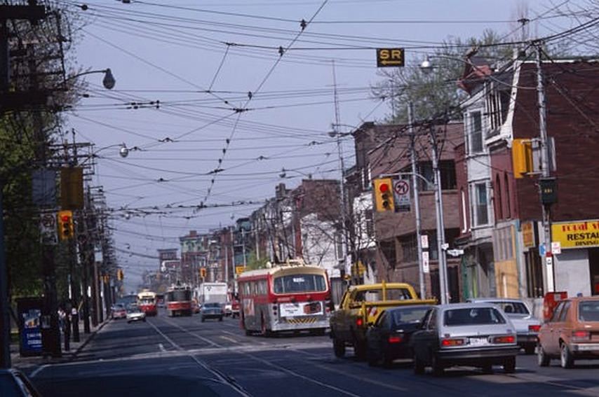 #124 Two types of streetcar and a trolley bus on Queen just west of Shaw, July 13, 1983.