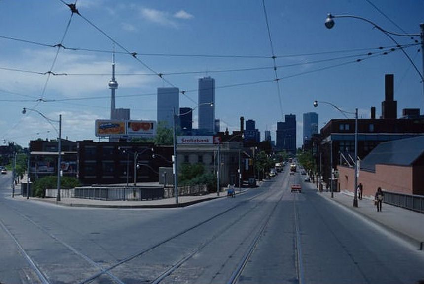 #129 Intersection of Queen and King at the Don River, looking west. No Scotia Plaza, yet. Exchange Tower is under construction behind First Canadian Place. June 2, 1981.