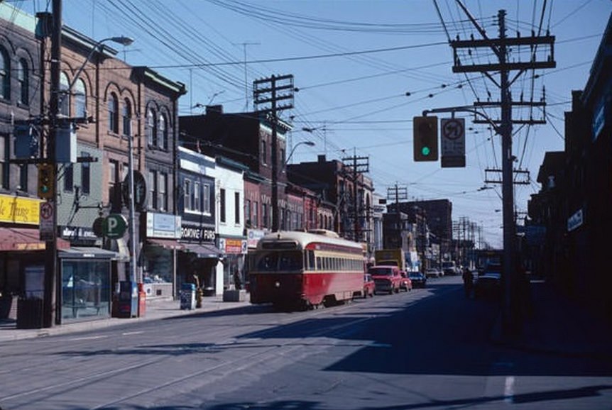 #130 Queen and Broadview, looking east at the stores on the north side of Queen, April 2, 1982.
