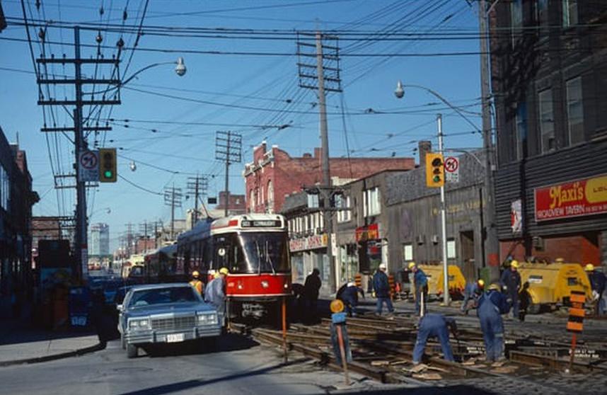 #73 Streetcars continue to operate at Queen and Broadview despite track work (Broadview Hotel is “Maxi’s,”) March 25, 1981