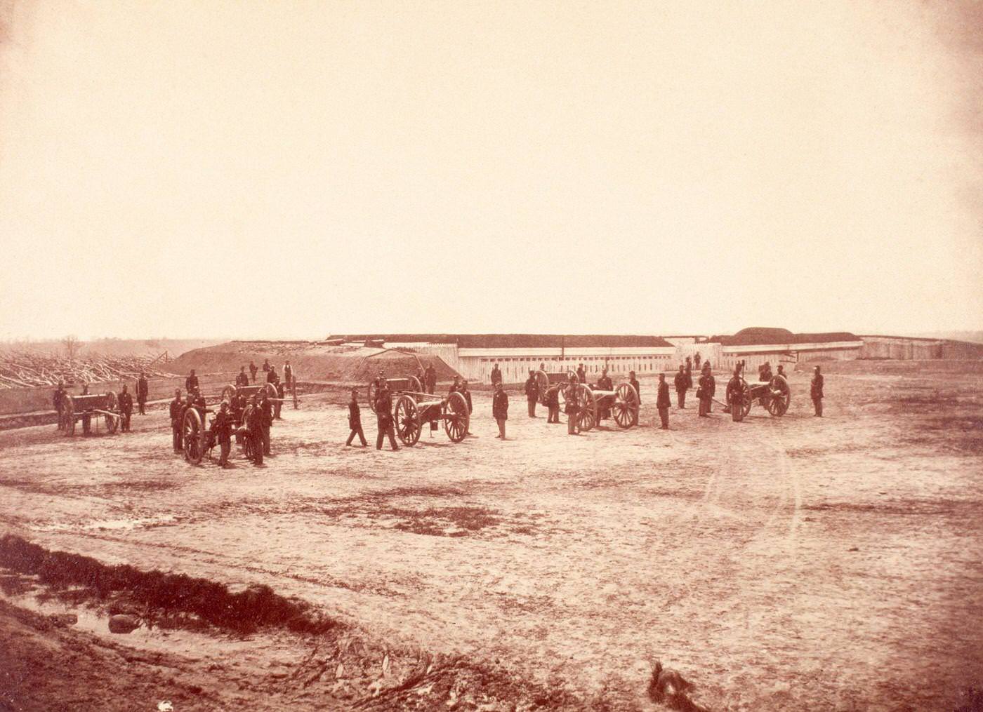 #97 Abatis surrounds the perimeter of Fort Lyon, Virginia, near where Union gunners pose with their cannons, 1860s