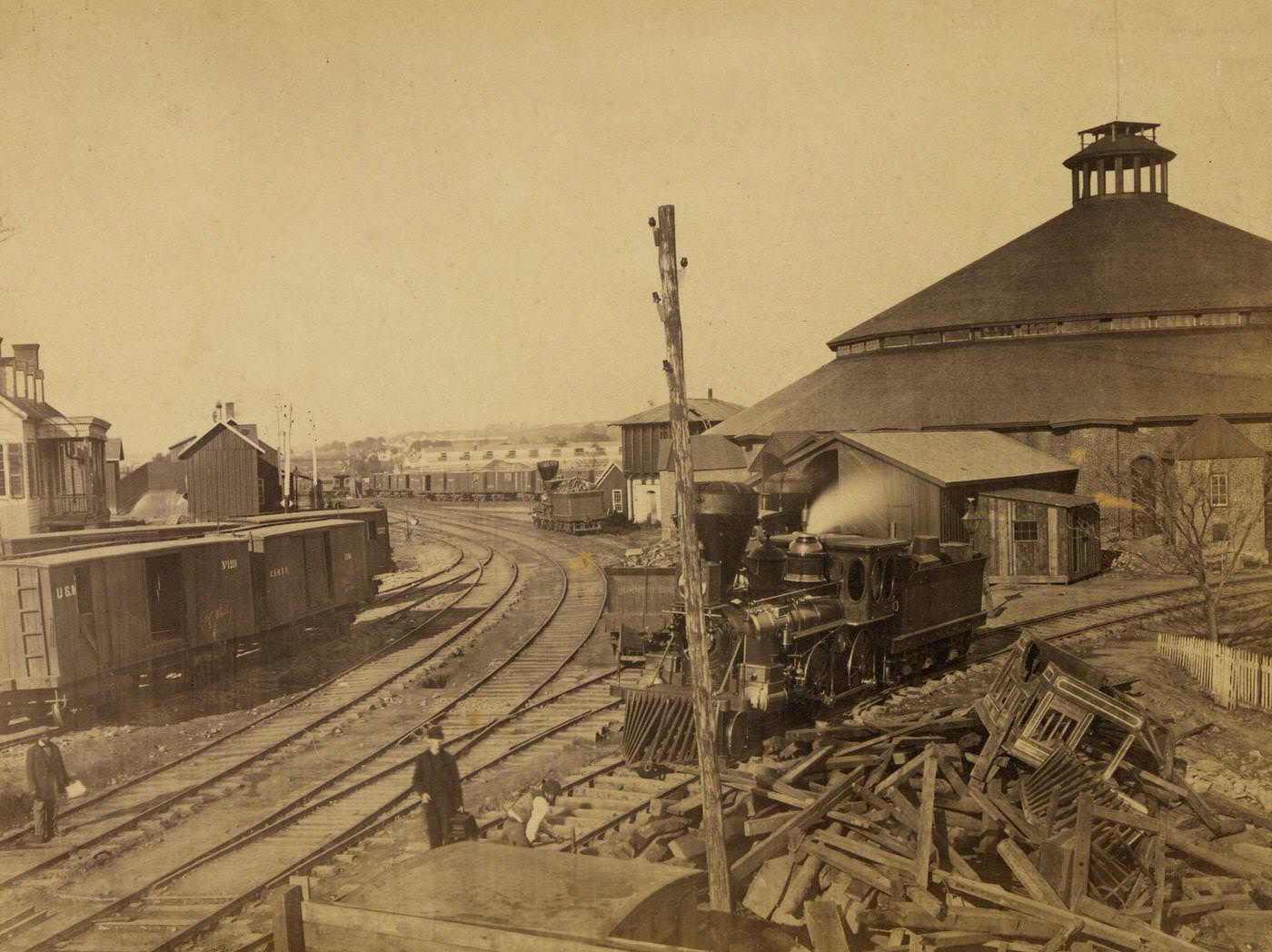 #117 Locomotive moving away from the roundhouse at the Orange & Alexandria railroad yard in Alexandria, Virginia, 1863