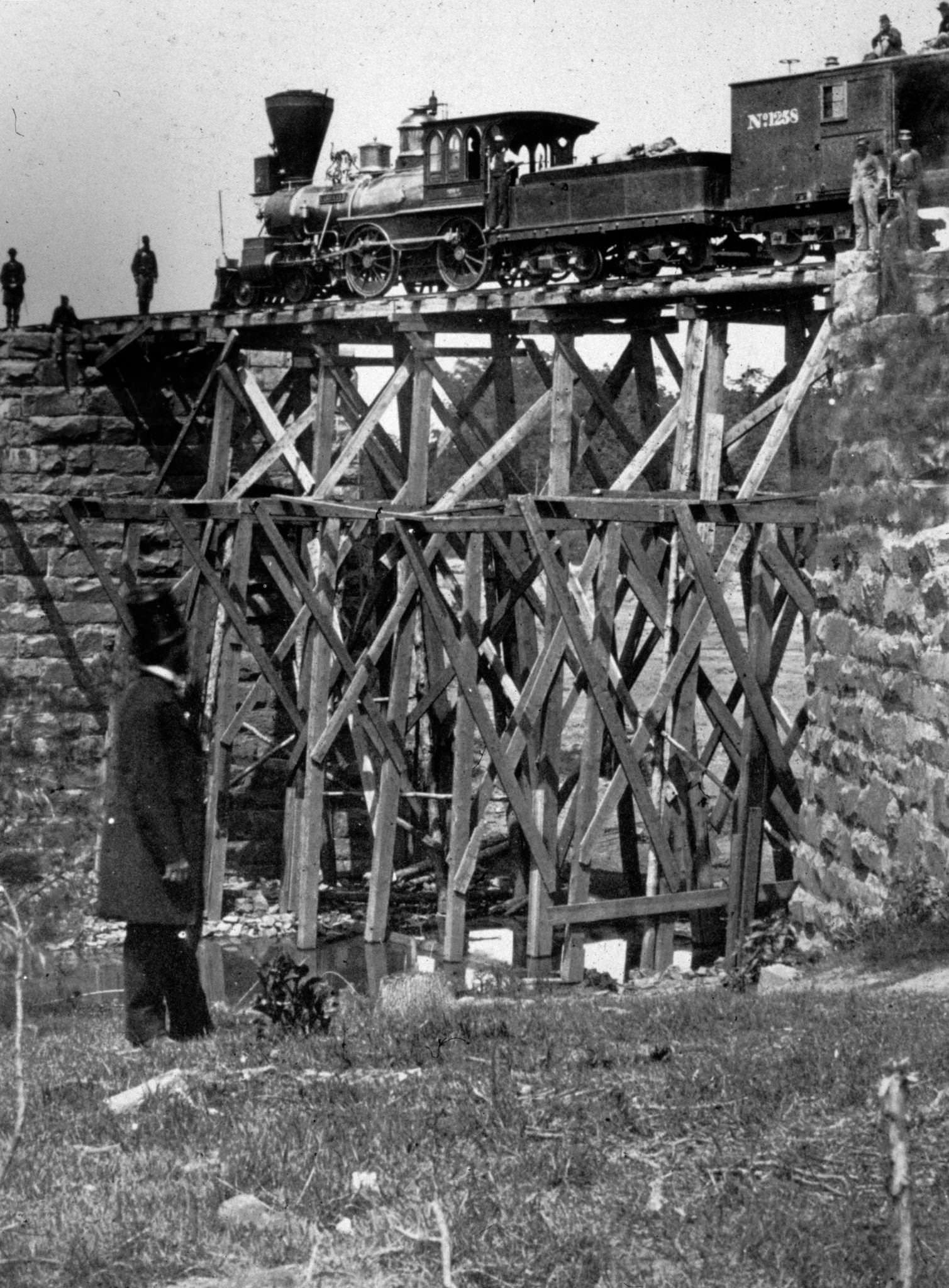 #125 The ‘Firefly’ railroad engine crossing a river on a trestle, a narrow field bridge of the Orange and Alexandria US Military Railroad, 1863