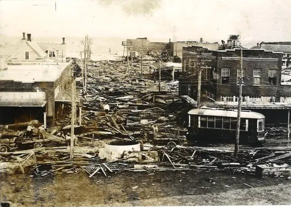 #79 Looking down Laguna Street toward Corpus Christi Bay following the Sept. 14, 1919 hurricane. The streetcar is on Mesquite Street. Laguna Street is now John Sartain Street.