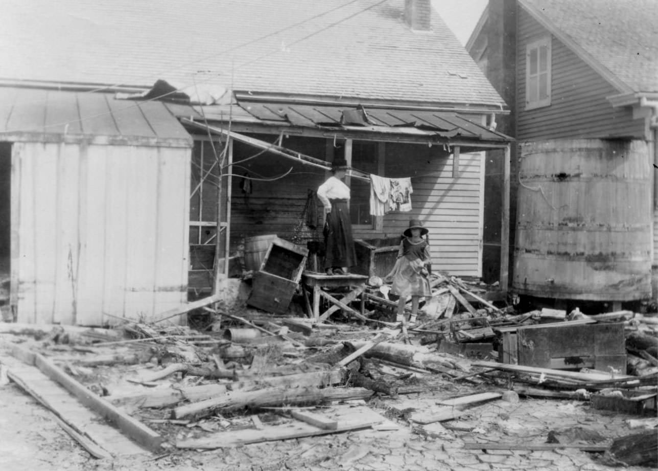 #43 A woman standing on her back porch looking over the debris and wreckage left by the hurricane of 1919 in Corpus Christi.