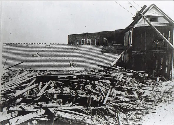 #76 The Plaza Hotel in downtown Corpus Christi ner Artesian Park was pushed into Chaparral Street by debris and the storm surge from the hurricane that hit Sept. 14, 1919.