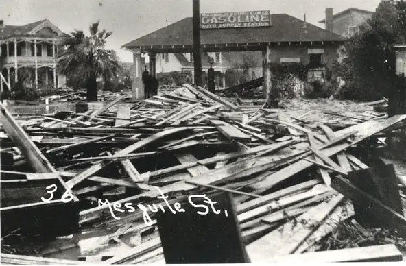 #81 The Magnolia Petroleum Co. auto supply and filling station at Mesquite and Taylor streets following the 1919 hurricane. The Gold Fish bar is currently at this location.