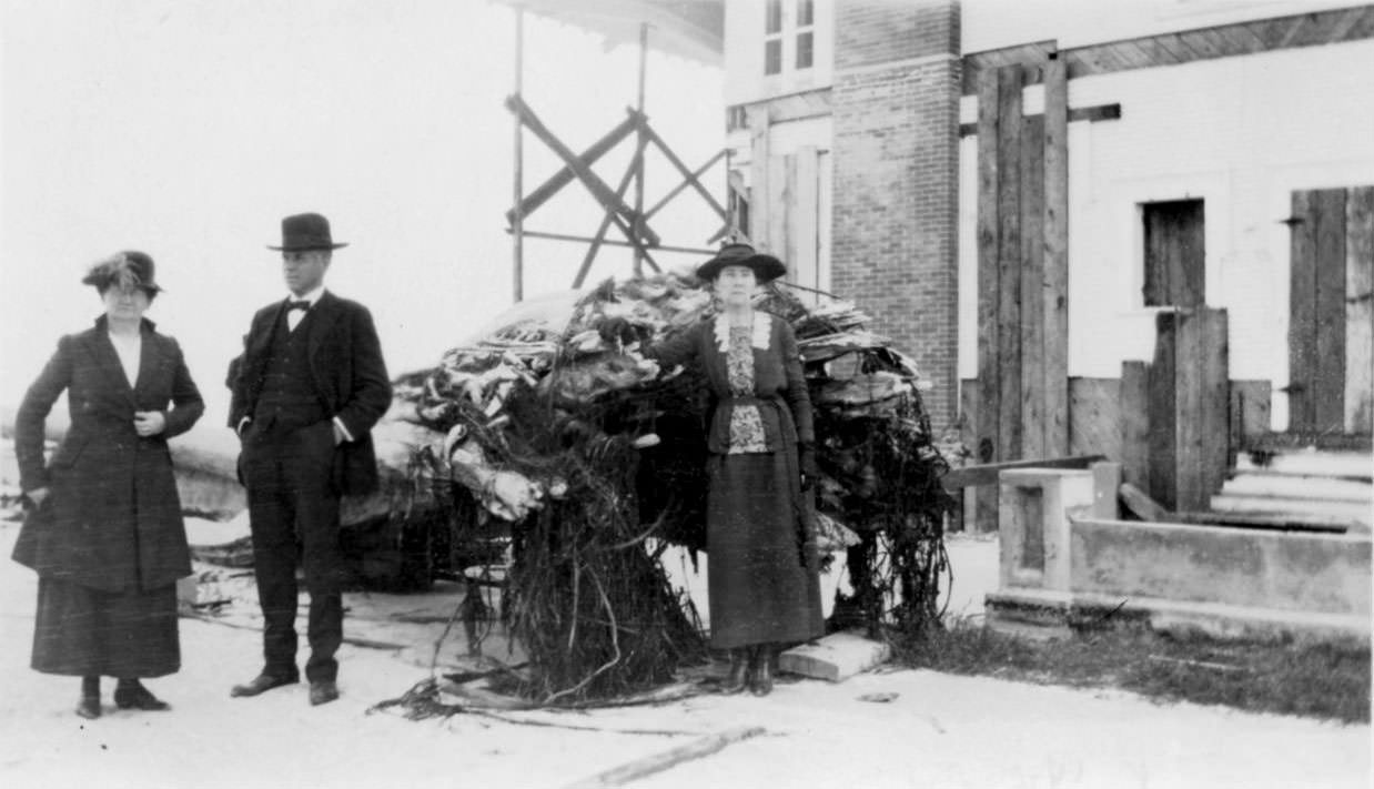 #29 Two women and a man standing by the ruins of a house after the 1919 hurricane in Corpus Christi.