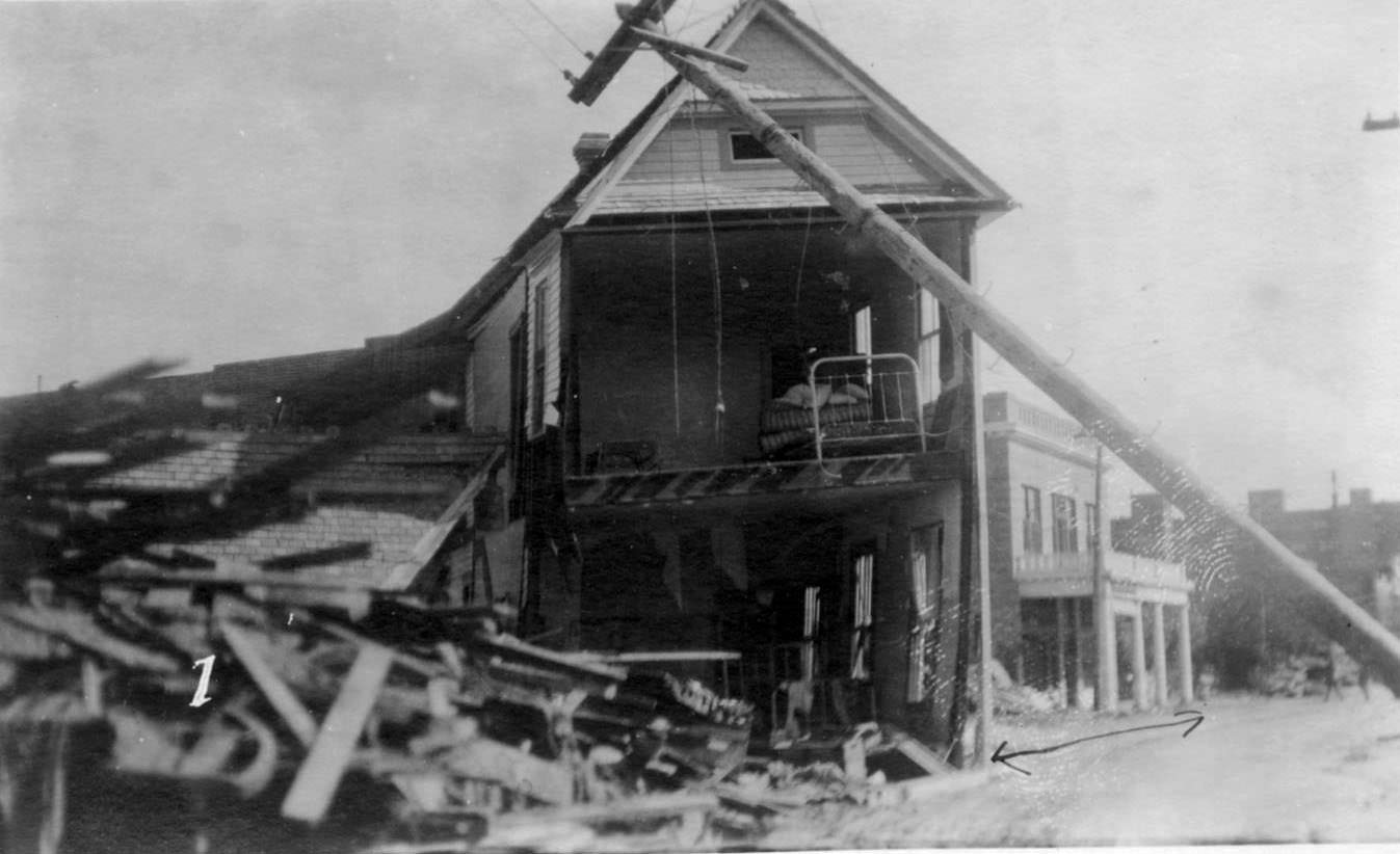 #54 The Winona Hotel with a pole leaning in the foreground. This was taken after the hurricane that hit Corpus Christi in 1919.
