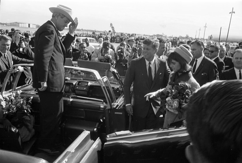 #120 President John F. Kennedy and wife Jackie Kennedy as they enter a convertible limousine at Love Field, Dallas, Texas, 1963