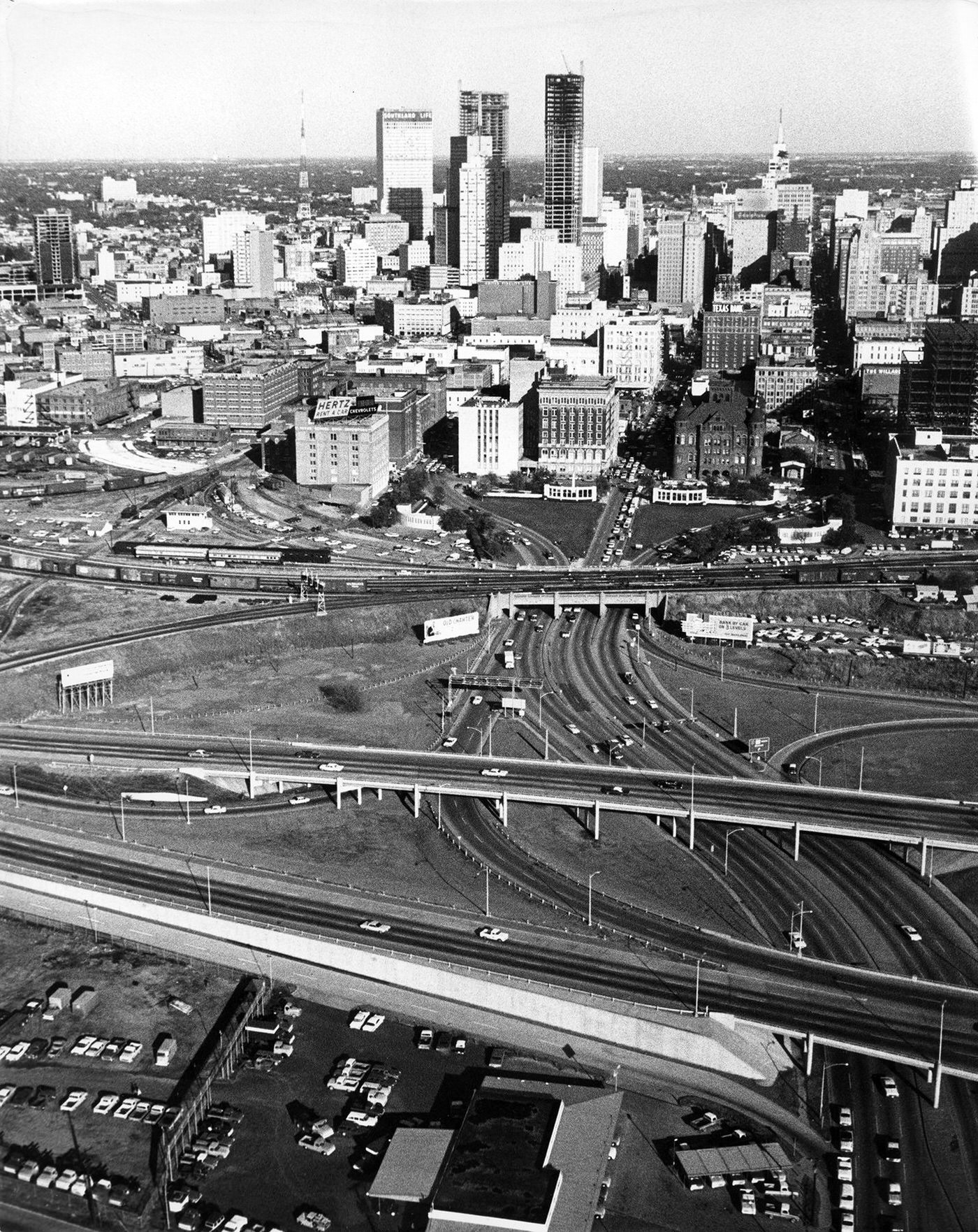 #145 A skyline view of Dallas showing Dealey Plaza, triple underpass, Texas School Book Depository building after assassination of President John F. Kennedy, 1963