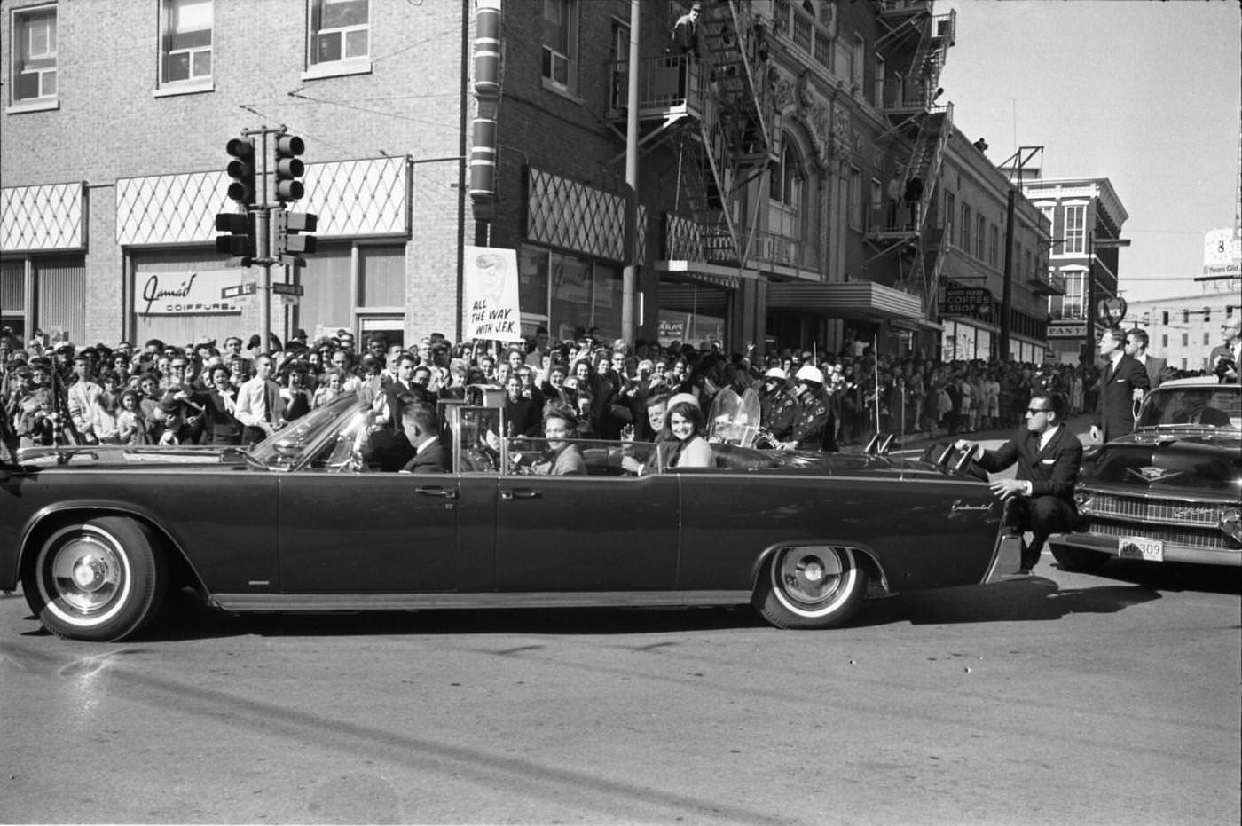#221 The presidential limousine turning onto main street in downtown Dallas, 1963