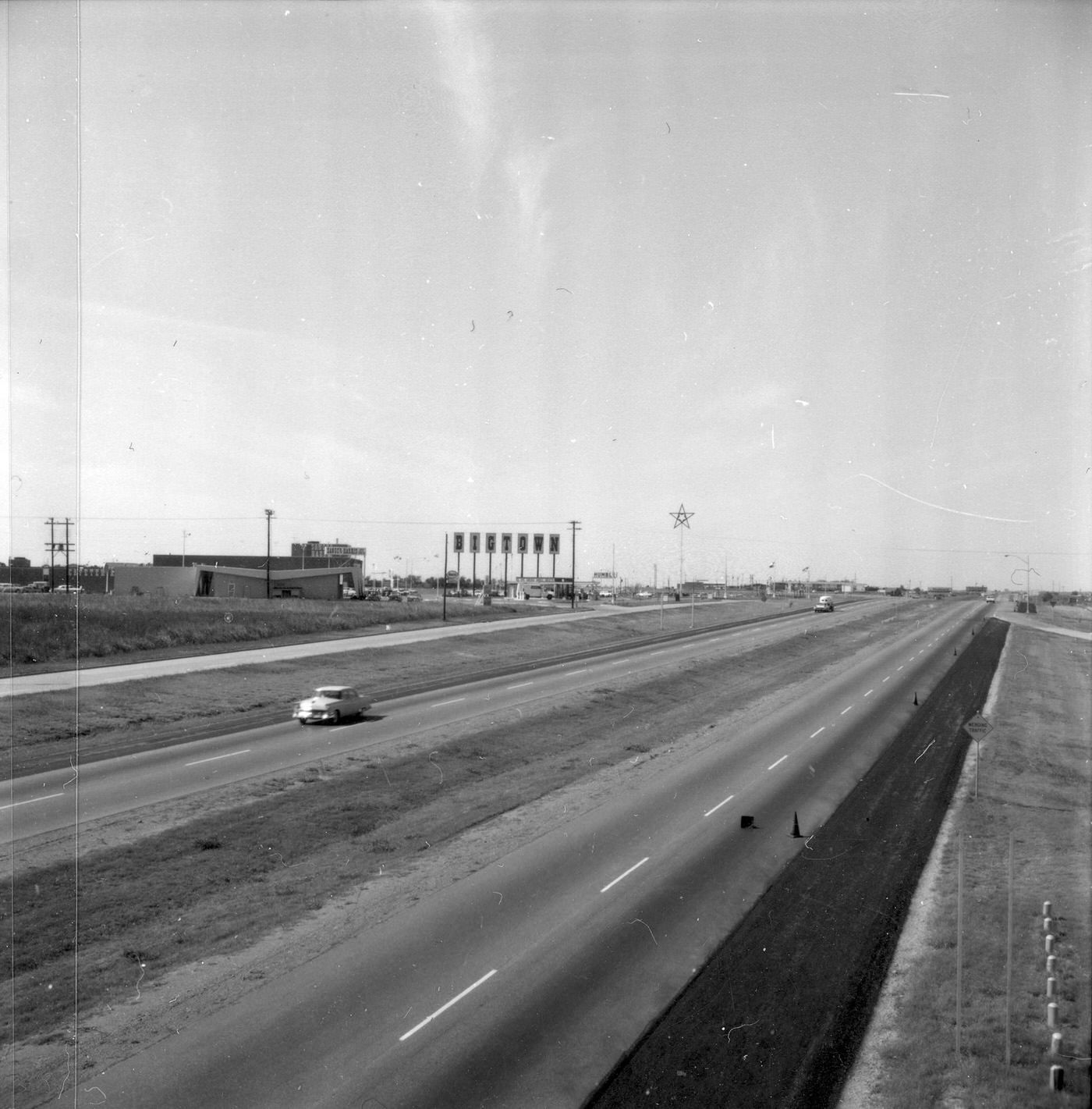 #56 The Dallas area highway with Bigtown sign on left, 1960
