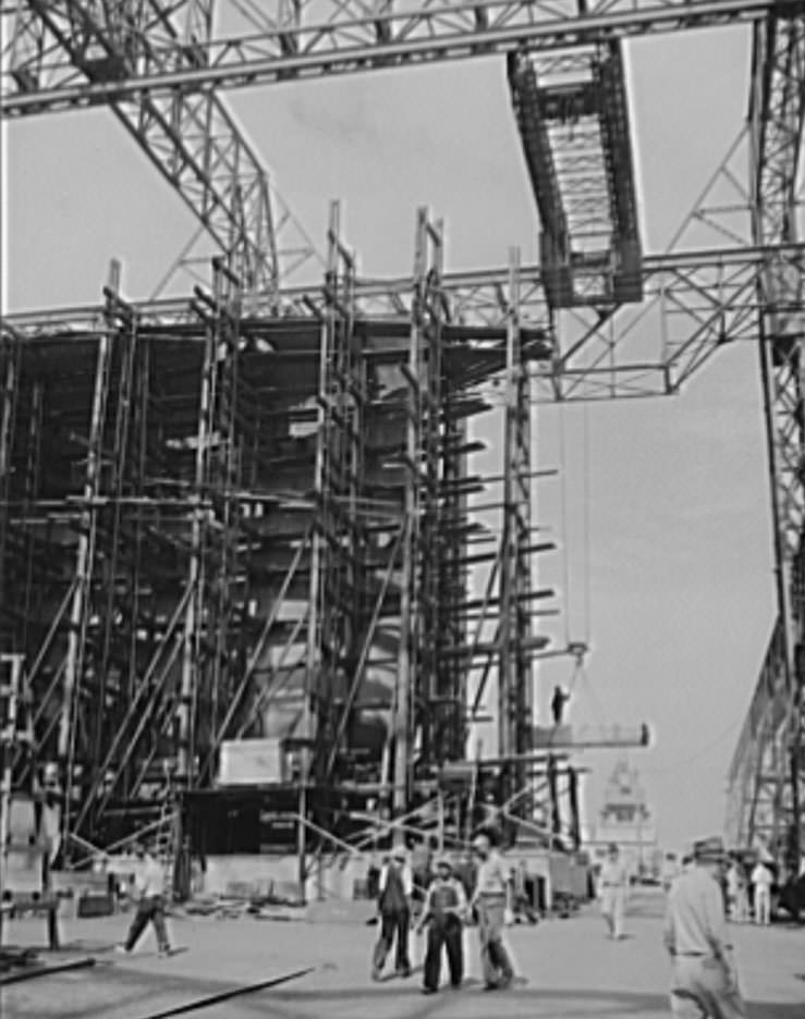 #11 Through the scaffolding may be seen the prow of a battleship under construction, 1941