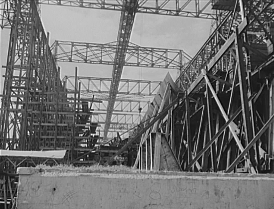 #12 Thousands of tons of lumber and steel are used in the construction of these ways, where American mechanical genius is employed in the production of ships for our new two-ocean Navy, 1941