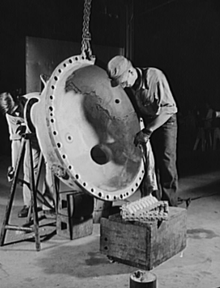 #43 These skilled workers are tinpleting an evaporator top, part of a stream turbine which will help to drive a news naval vessel under construction at the Newport News, 1941