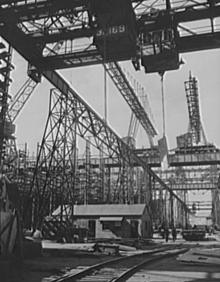 #49 Thousands of tons of lumber and steel are used in the construction of these ways, where American mechanical genius is employed in the production of ships for our new two-ocean Navy, 1941