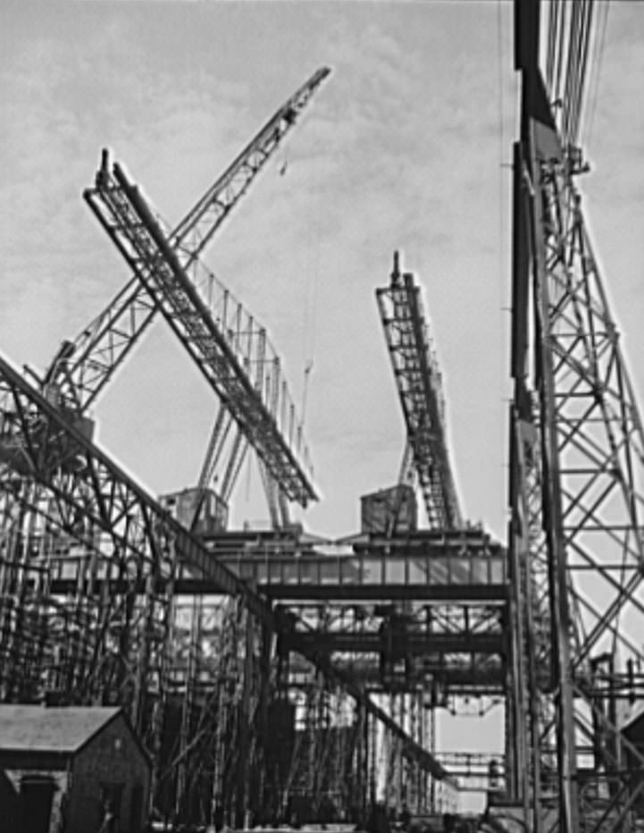 #53 Huge overhead cranes are used for the placing of heavy parts in the naval ships under construction at these ways, 1941
