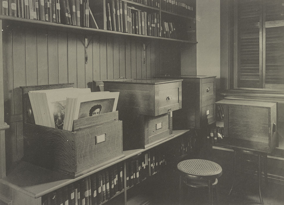 #16 Alcove containing books on art, showing cabinets for storing photographs, 1900