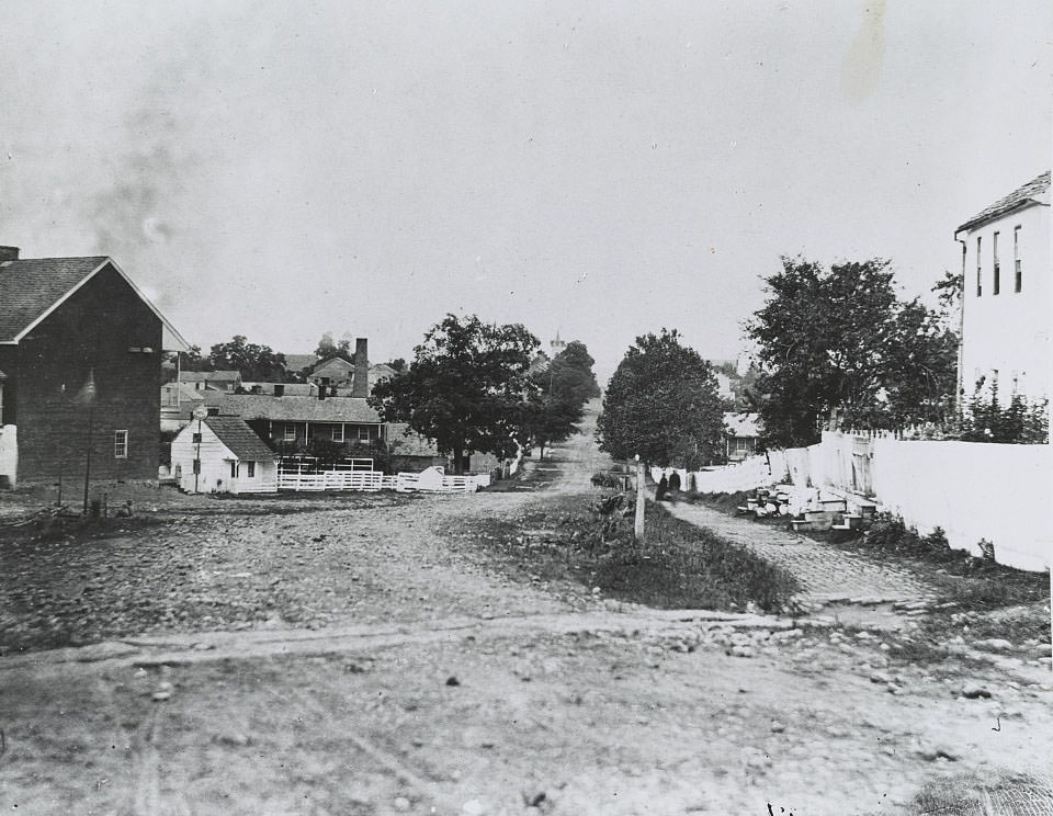 #31 Homes along a dirt road. View may be of Gettysburg rather than Petersburg, 1865