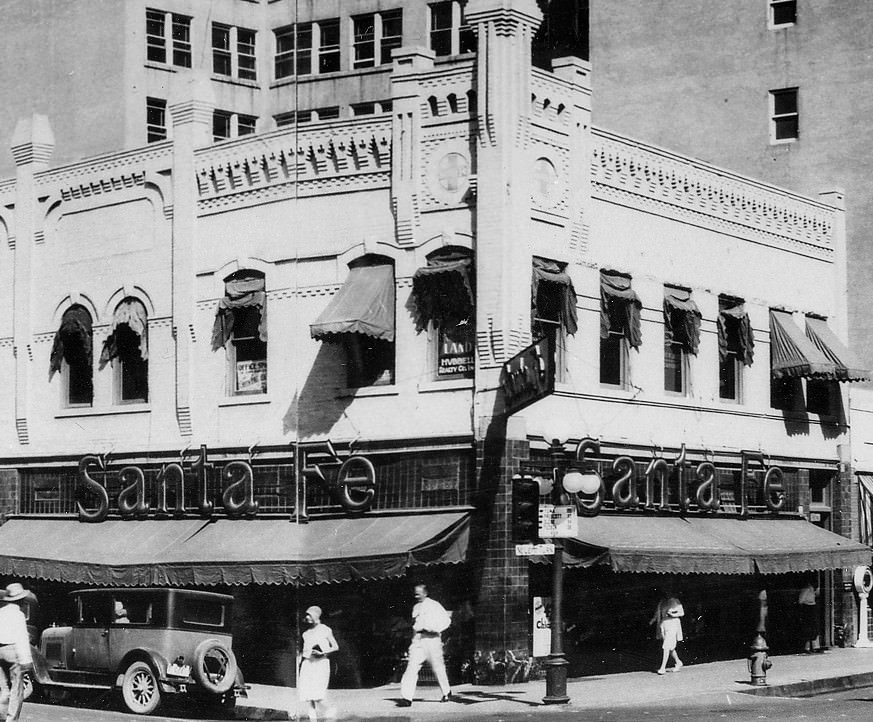 #98 The AT&SF Railway ticket office on the northwest corner of Adams and Central. It’s still there, under ugly stucco. The city’s ubiquitous awnings were real “shade structures.”