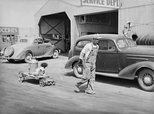 #83 A man hauls water to his home in Phoenix in May 1940.