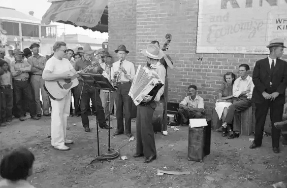 #96 An orchestra plays outside a Phoenix grocery store on Saturday afternoon in May 1940.