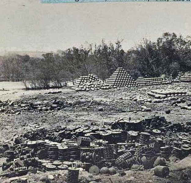#123 Arsenal grounds, Richmond, Va., showing ruins and shot and shell scattered around. 1865.