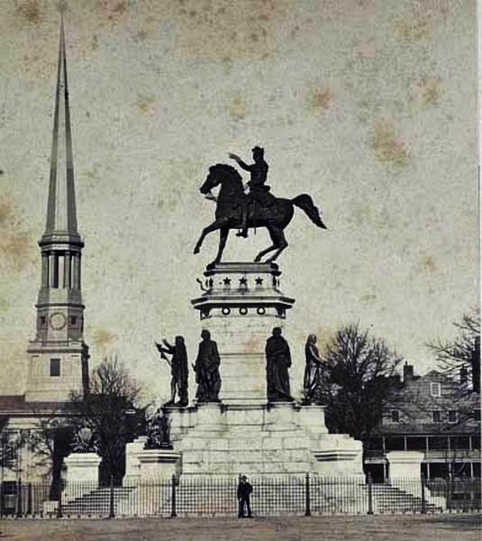 #45 The Virginia Washington Monument in Capitol Square in Richmond, Virginia with the spire of St. Paul’s Church on the left, 1860