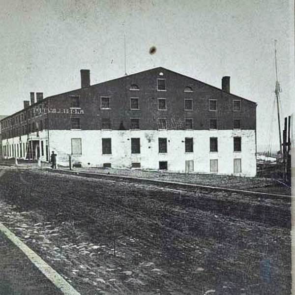#112 A man standing in front of Libby Prison, a Confederate facility in Richmond, Virginia, 1860