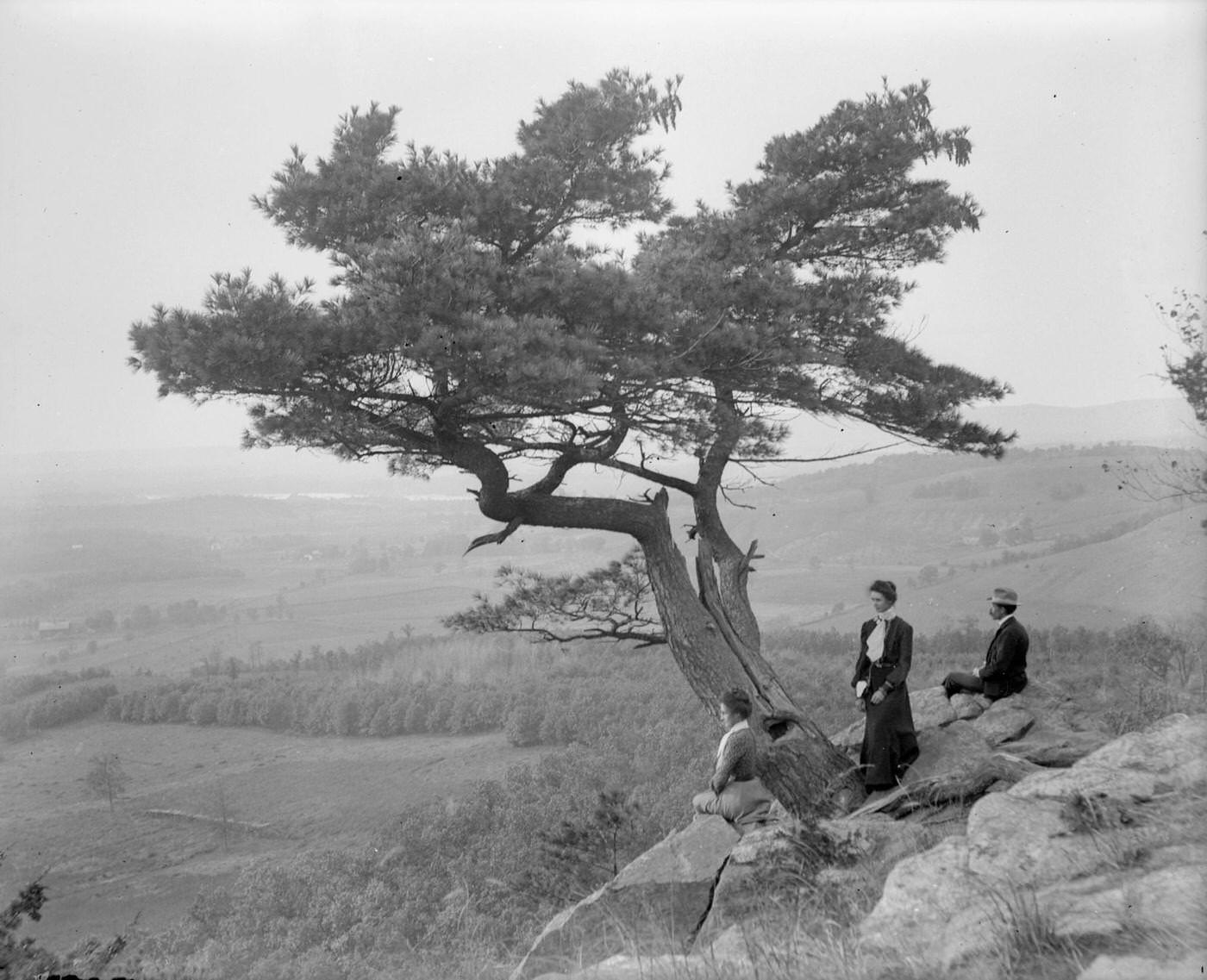 #118 Two women and a man pose atop Gibraltar Rock in Richmond Memorial Park, which was dedicated by Jens Jensen and the Wisconsin Friends in 1927 in order to conserve the native landscape, West Point, Wisconsin, 1902.