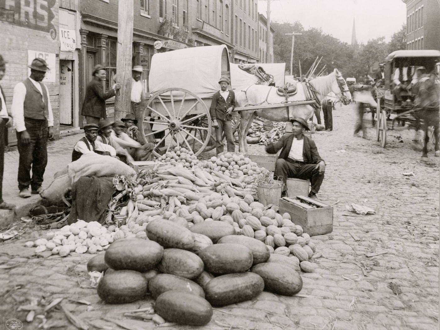 #120 Sixth Street market, Richmond, Va African-American vendors and farm produce–melons, corn and squash, 1908