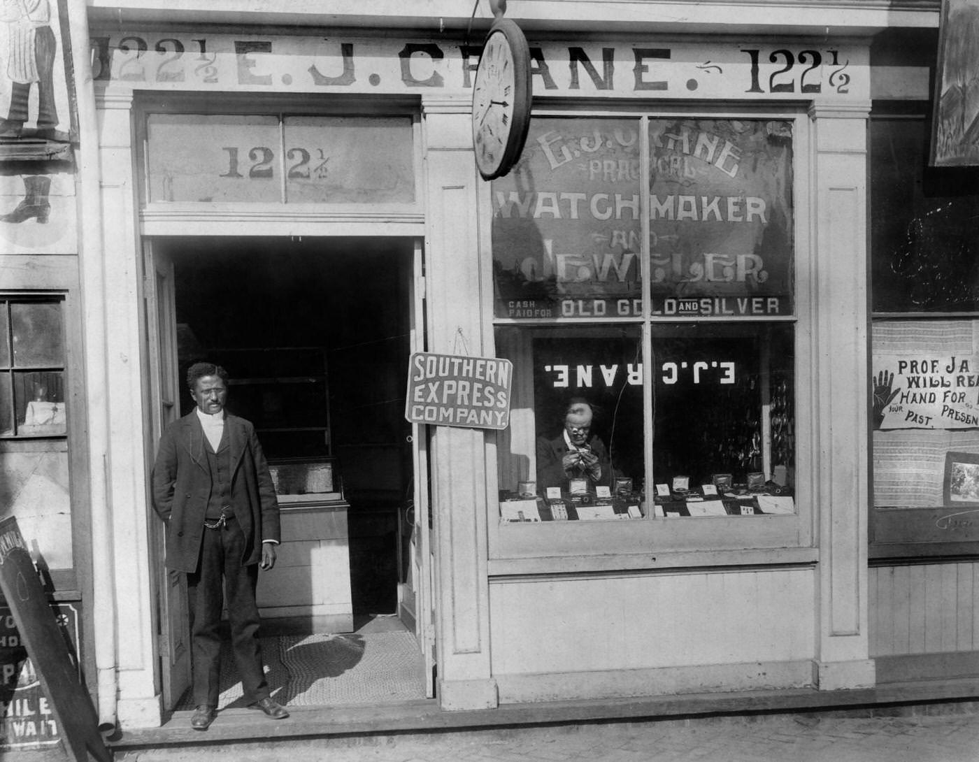 #121 Man Working in Window and Man Standing in Doorway, EJ Crane Watchmaker and Jewelry Store, Richmond, Virginia, 1900