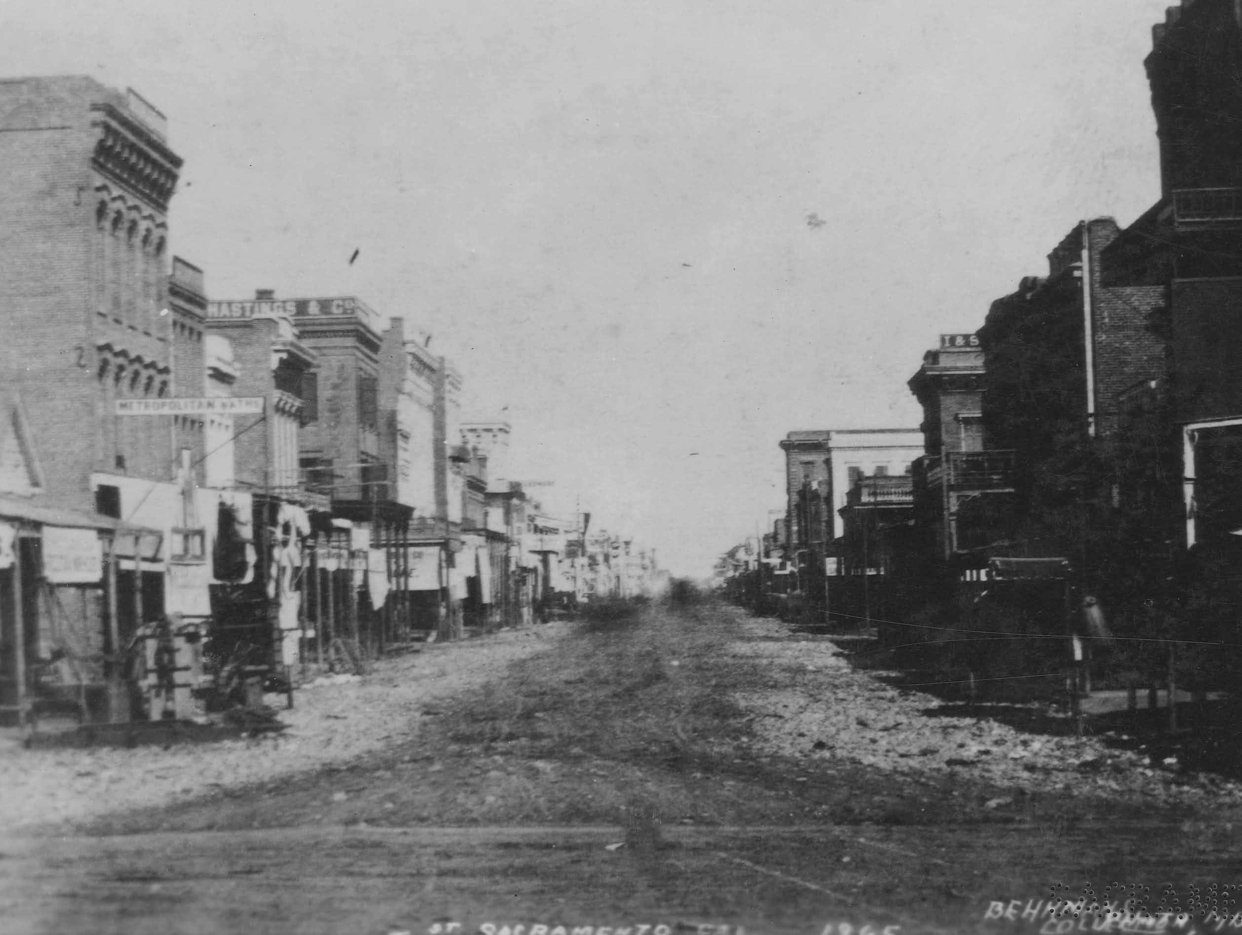 #84 A view down J Street, showing, to the right, both the Metropolitan Baths and B.F. Hastings and Company, 1868