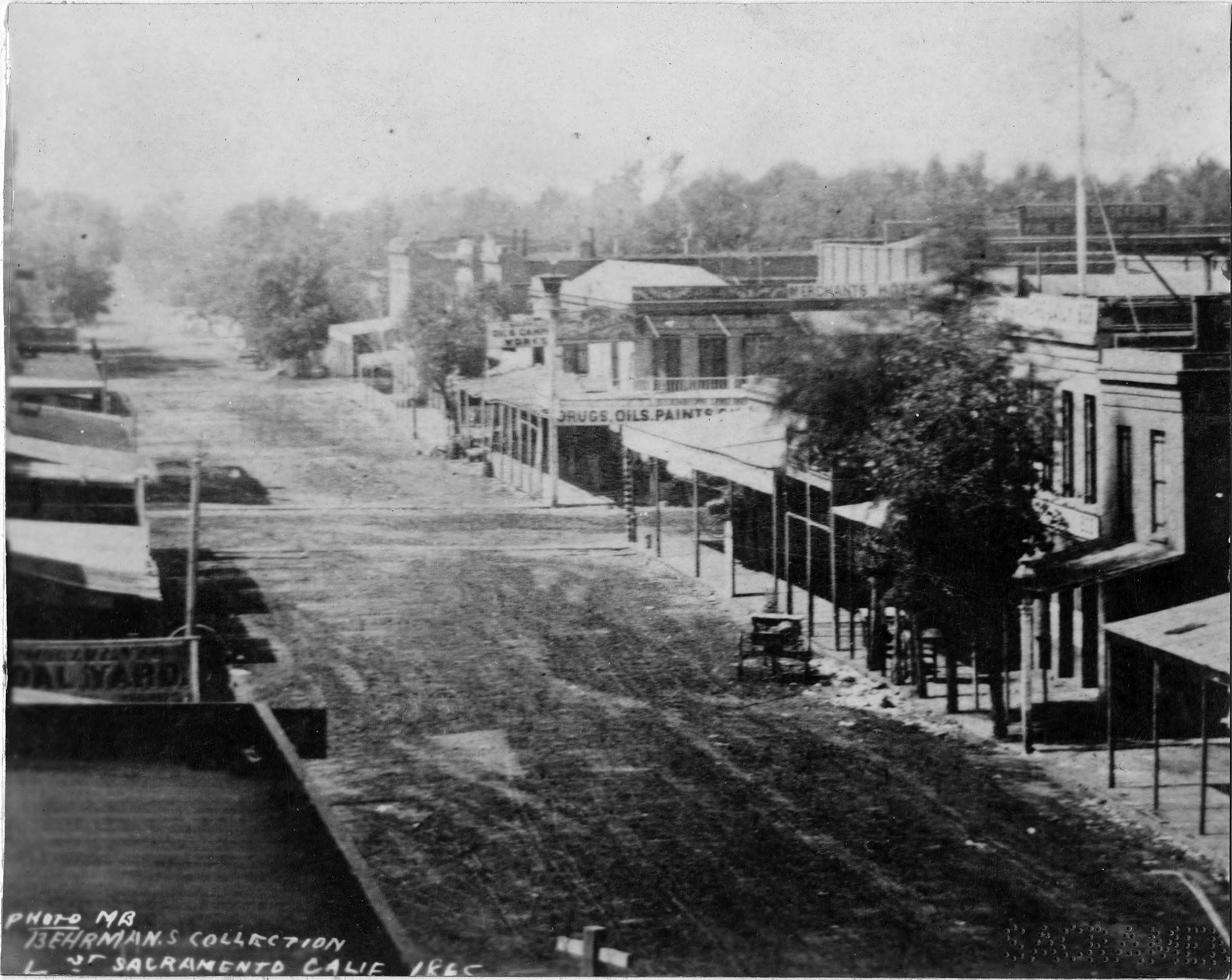 #106 L Street circa 1865 is depicted with unpaved streets and wooden sidewalks, 1865