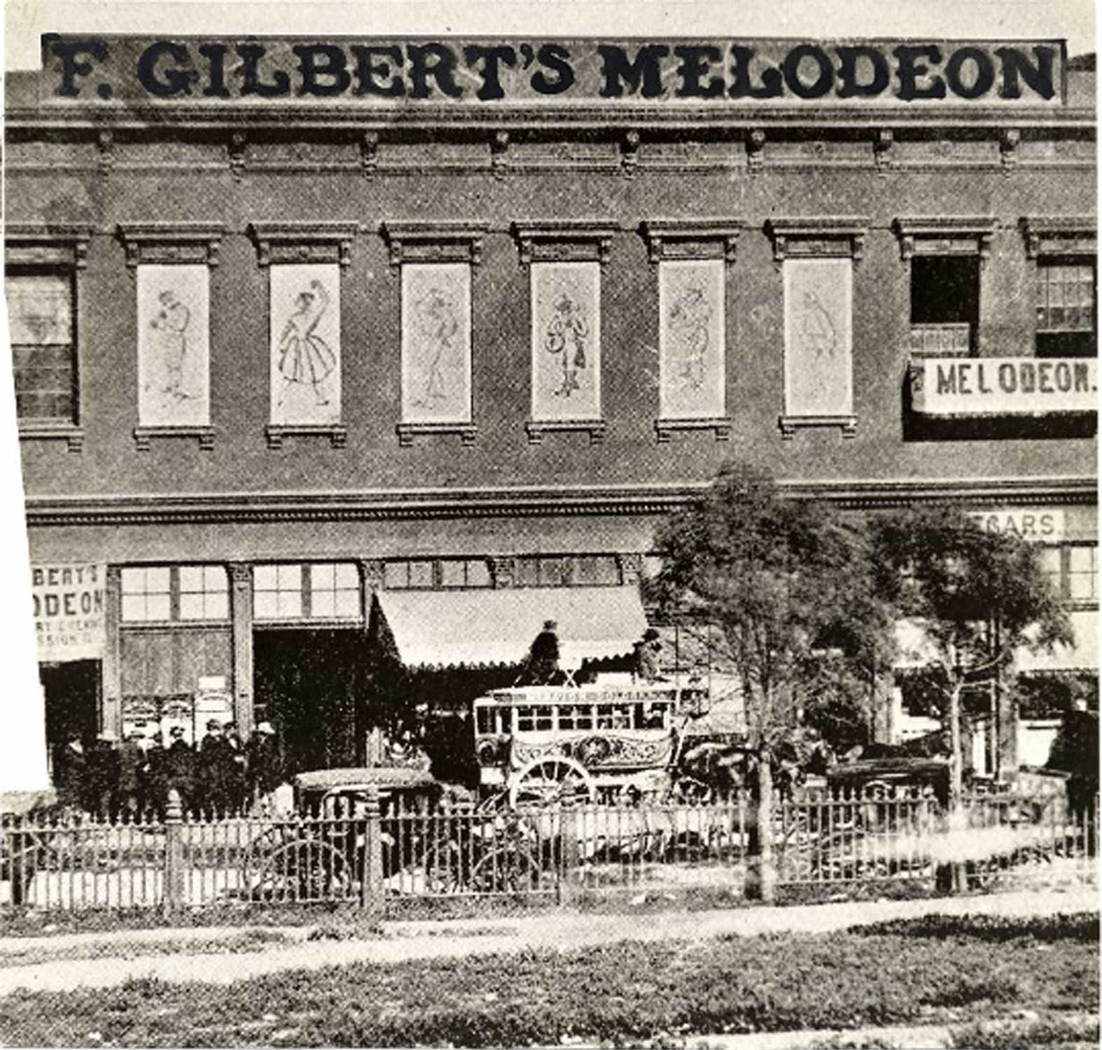 #8 A stagecoach and several unidentified people outside of the F. Gilbert’s Melodeon theater located at Clay and Kearny Streets, 1854