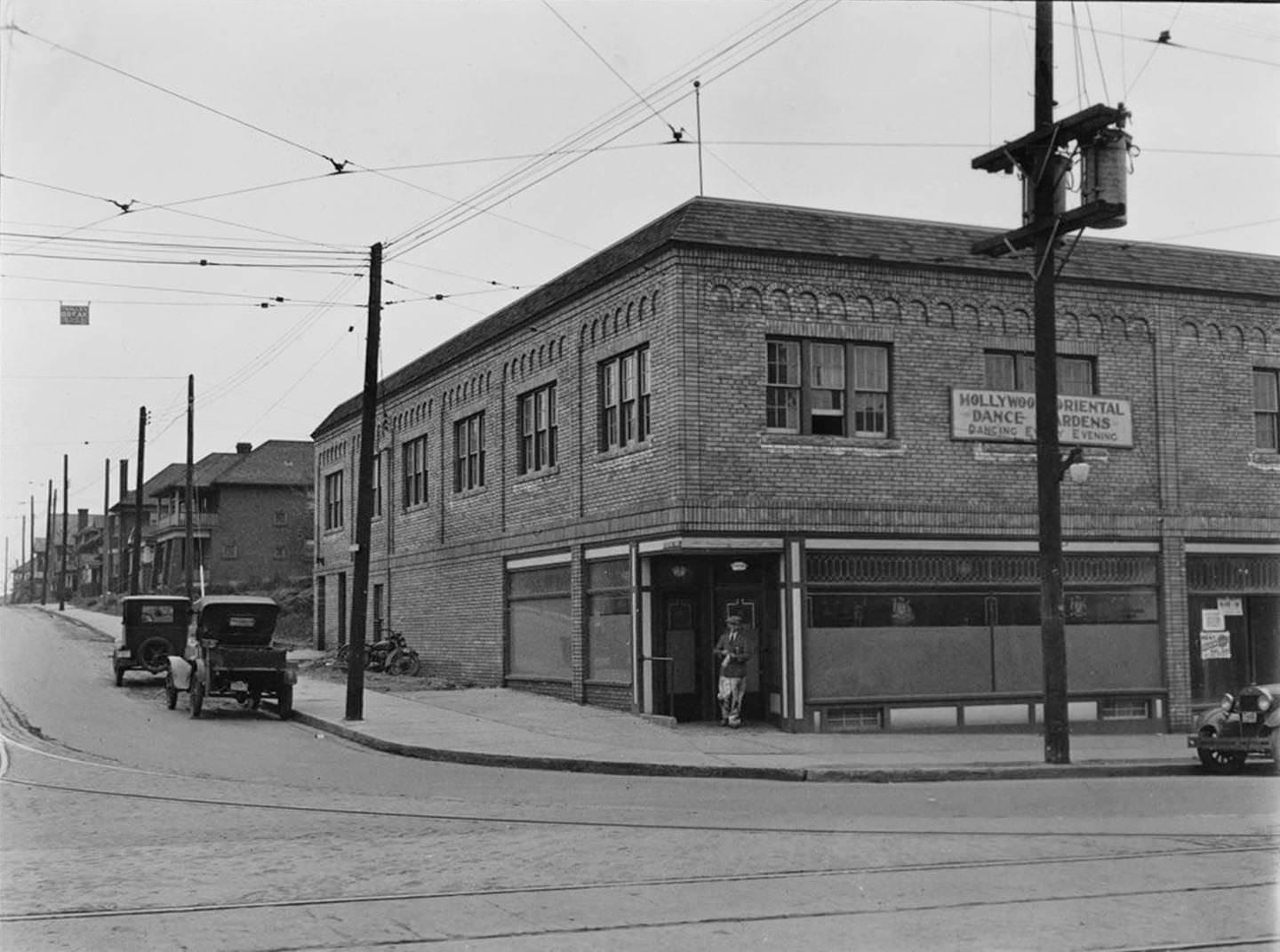 #148 A customer emerges with their brown paper bag from the LCBO liquor store at Robina Ave. and St. Clair Ave. W., March 18, 1930.