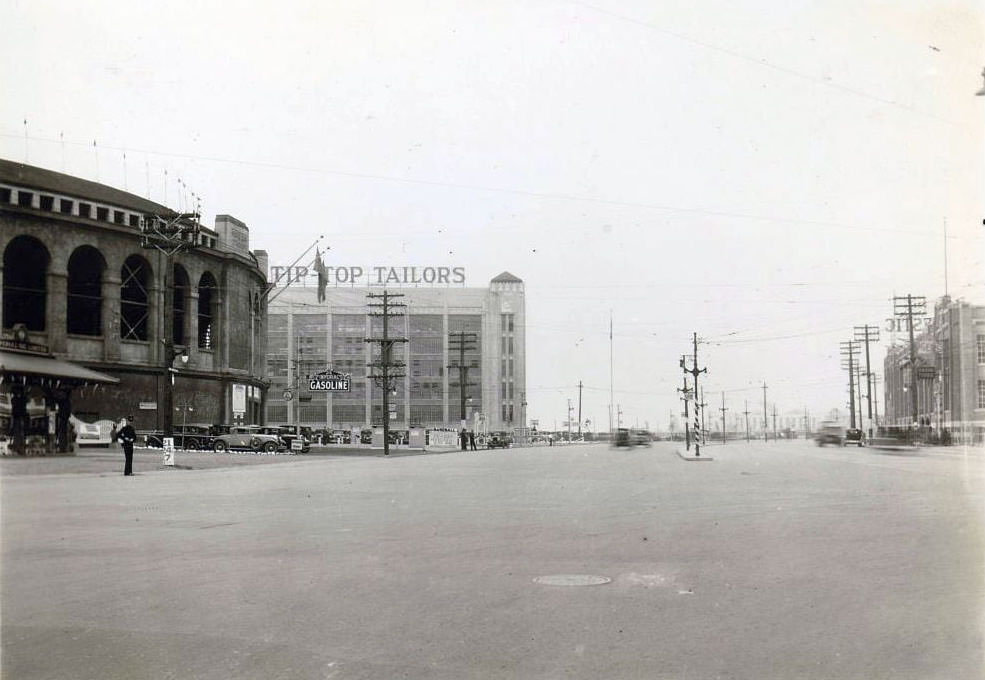 #72 Lake Shore Road and Bathurst Street. Visible in the image is Tip Top Tailors and Maple Leaf Stadium, on the left, and Rogers-Majestic on the right, 1930