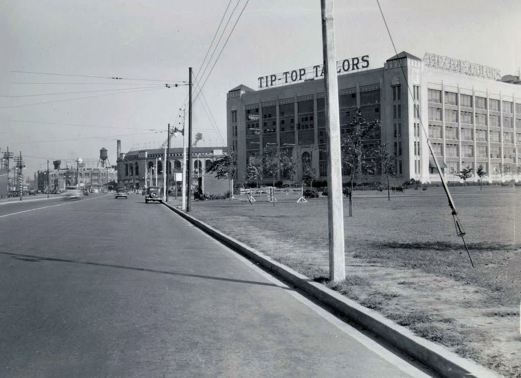 #155 Tip-Top Tailors building, Lake Shore Road at Stadium Road. Maple Leaf Stadium is visible in the background. View is looking east, 1935