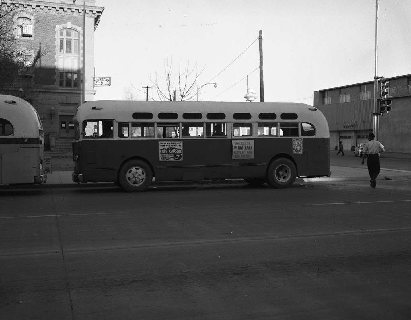 #156 A bus stopped at a bus stop near an intersection in downtown Abilene, 1955