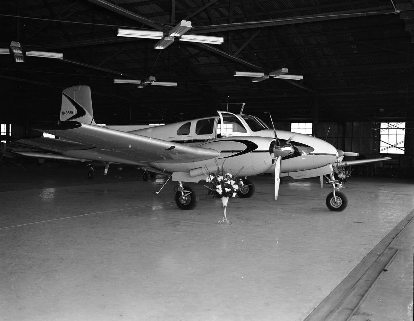 #51 A Beechcraft Model 50 Twin Bonanza inside a hanger at the Jack Hughes Airport in Abilene, Texas, 1956