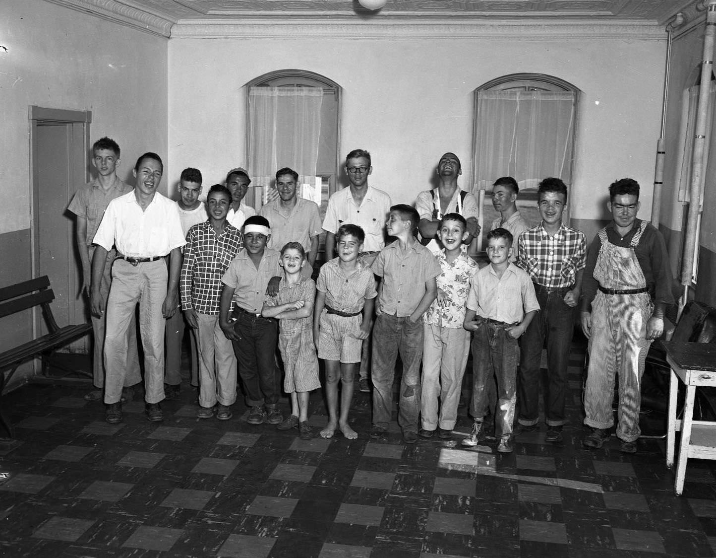 #41 A group of boys at the Abilene Boys Ranch. The boys are standing in two rows in a mostly empty room. The younger boys stand in the first row.