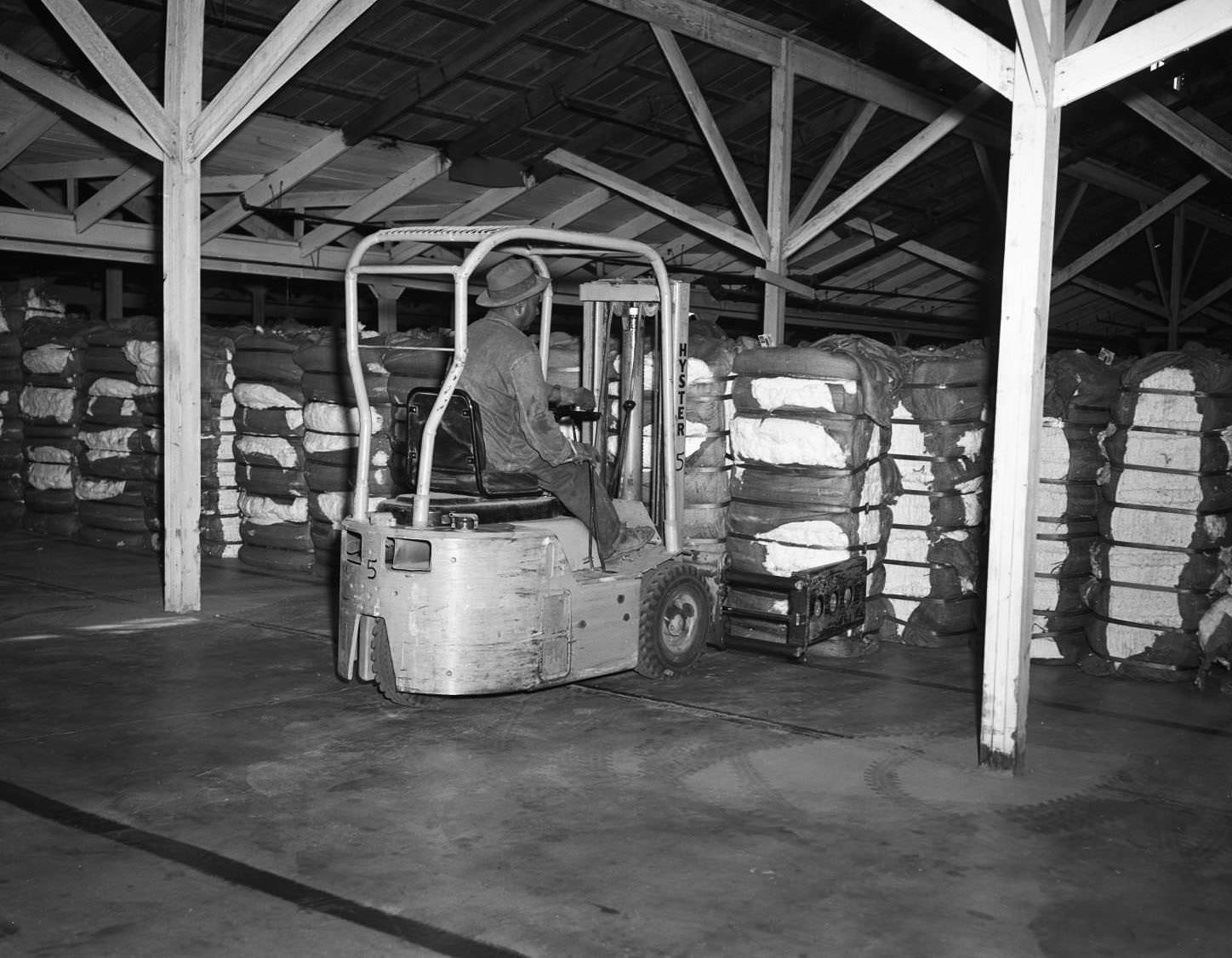 #14 A man loading a forklift with compressed cotton in Abilene, Texas, 1956