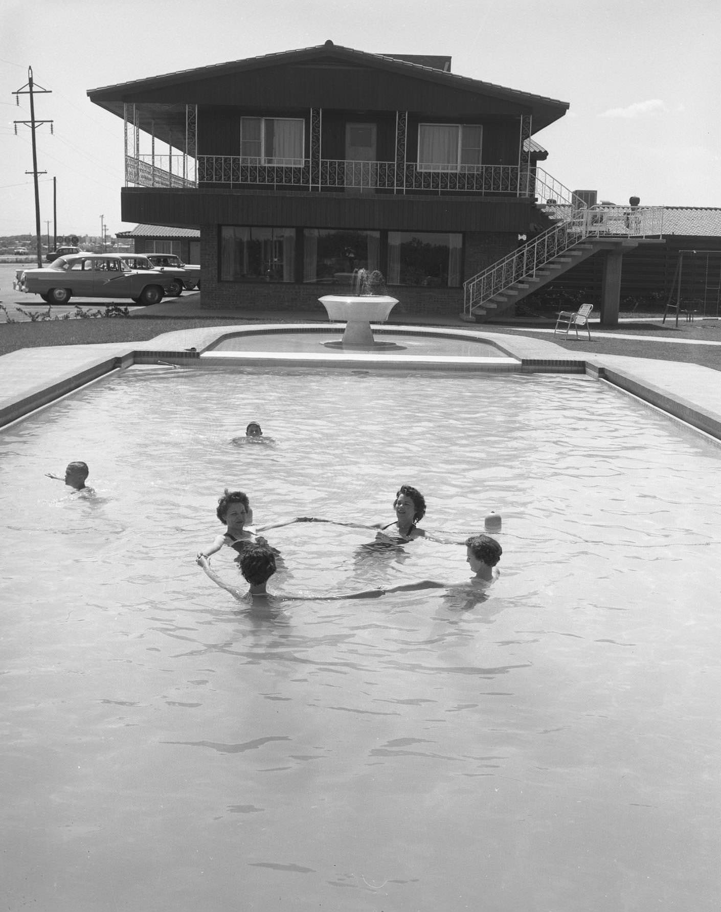 #83 A group of people in the Thunderbird Lodge Hotel swimming pool, 1950s