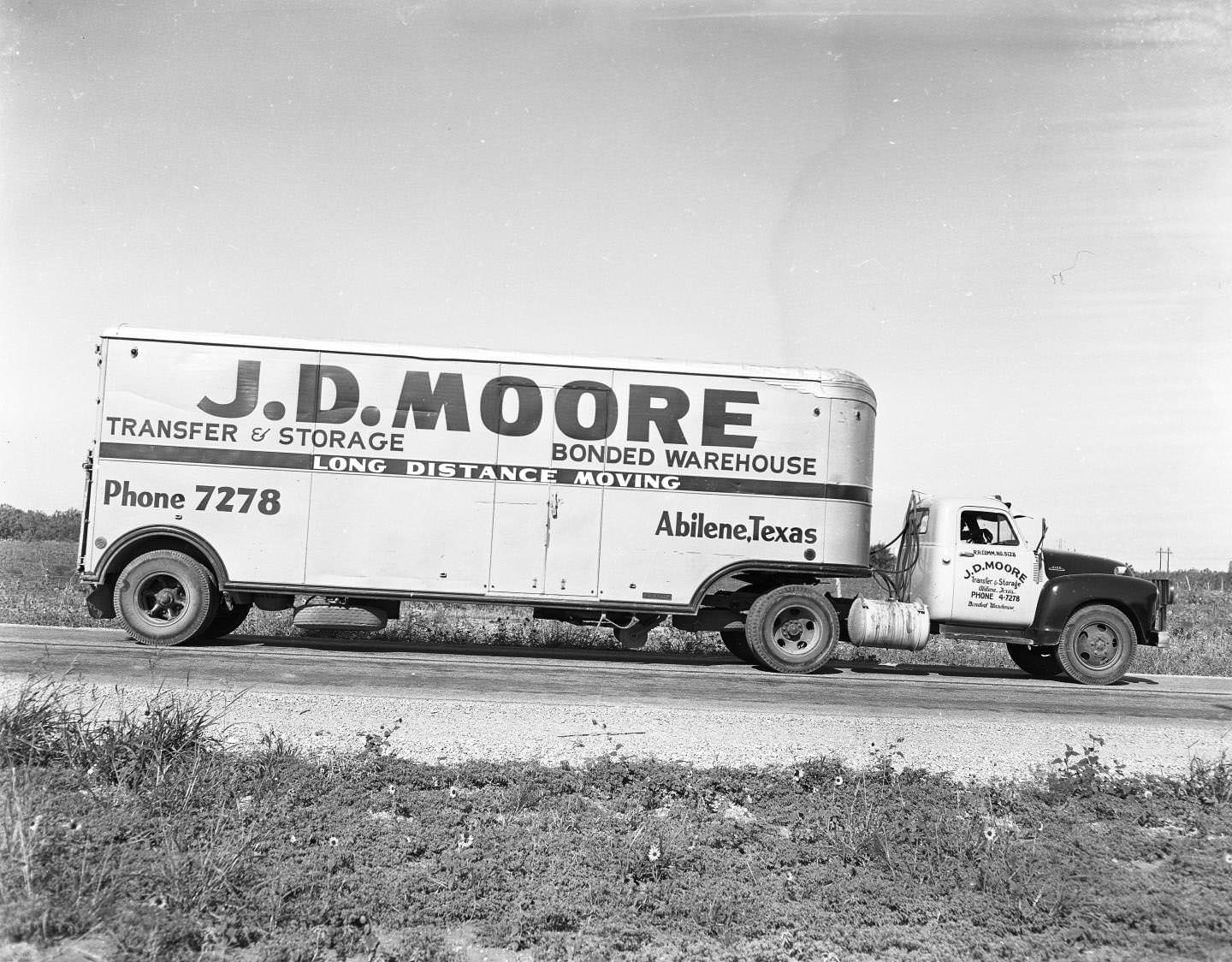 #198 A J. D. Moore moving truck on the side of the road, 1958
