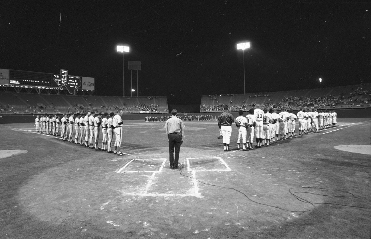 #45 Texas Rangers opening night at Arlington Stadium; Rangers vs. California Angels; players lined up for national anthem, 1972